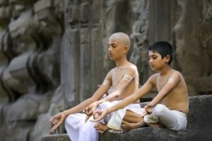 indian priest childs doing yoga